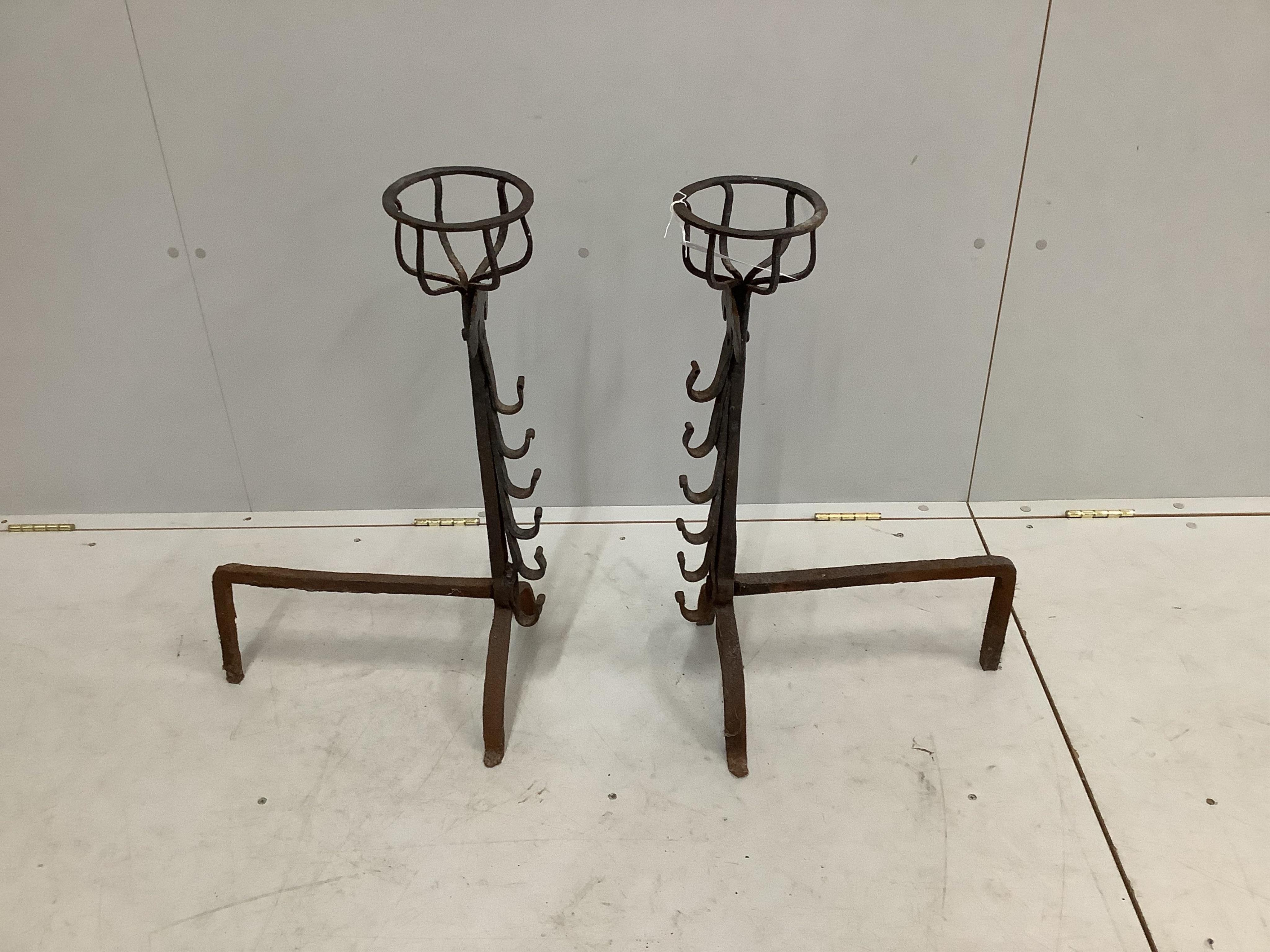 A pair of wrought iron fire dogs, height 70cm. Condition - fair